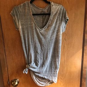 Plain grey T-shirt with simple tie in the front.